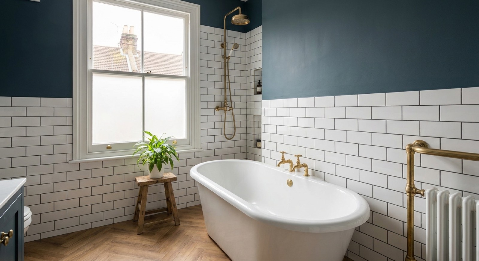 Renovated bathroom in a Victorian south London terrace with freestanding bath and metro tiles